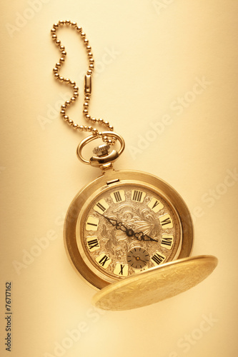 Golden pocket watch with chain