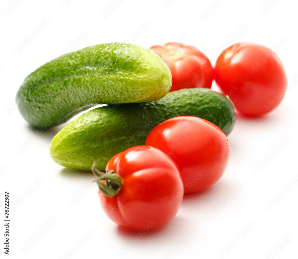 Fresh cucumbers and tomatoes on white Fresh cucumbers and tomatoes on white