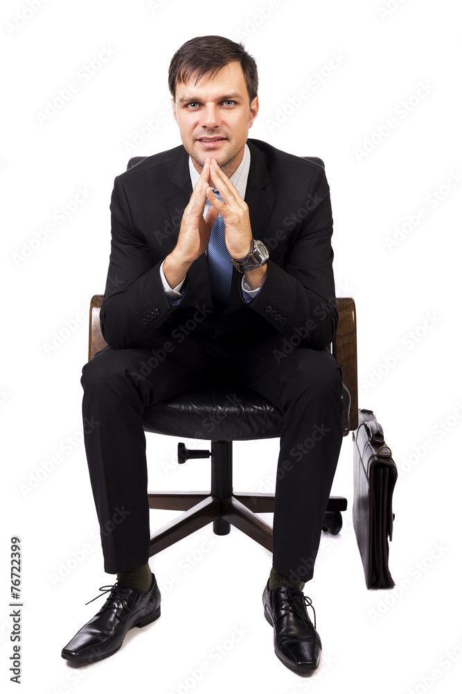 Portrait of handsome young businessman sitting on chair Portrait of handsome young businessman sitting on chair