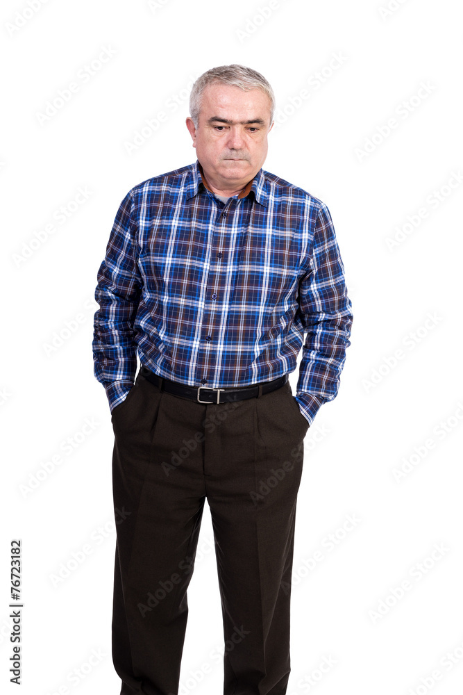 Portrait of a sad senior man with hands in his pockets looking d Portrait of a sad senior man with hands in his pockets looking d