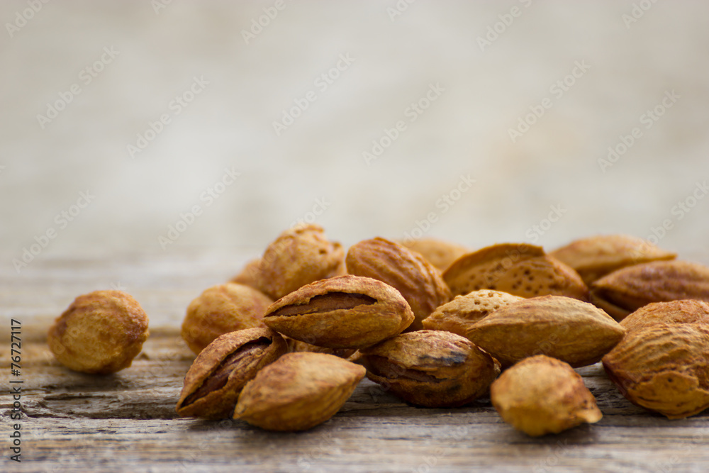 Roasted almonds on wood