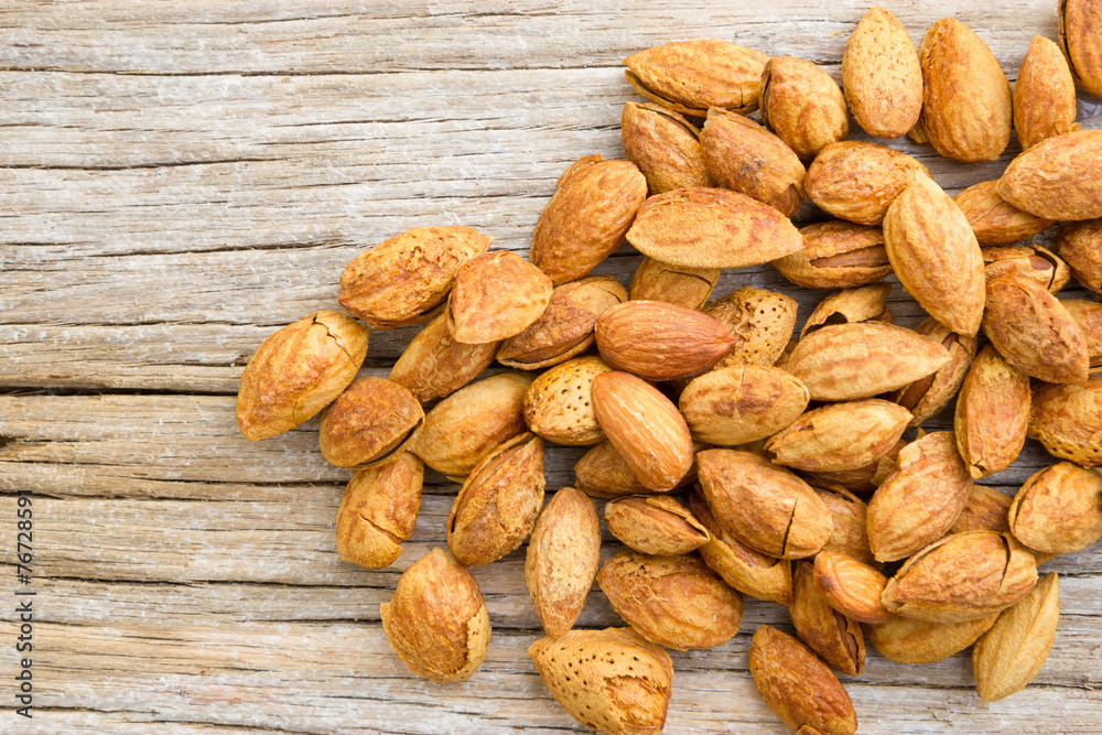 Roasted almonds on wood Roasted almonds on wood