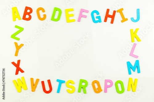 Alphabet magnets forming frame on whiteboard