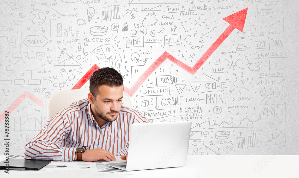 Business man sitting at table with market diagrams Business man sitting at table with market diagrams