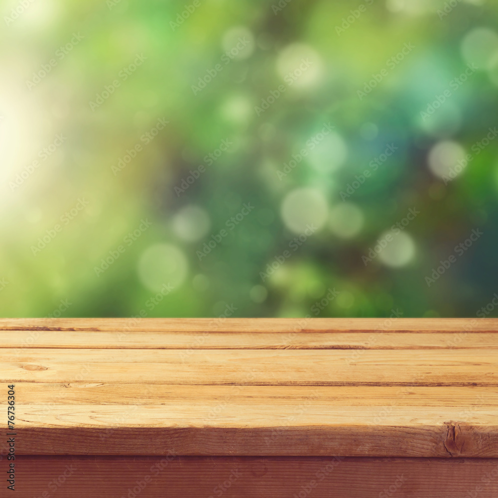 Wooden deck table with garden bokeh background Wooden deck table with garden bokeh background