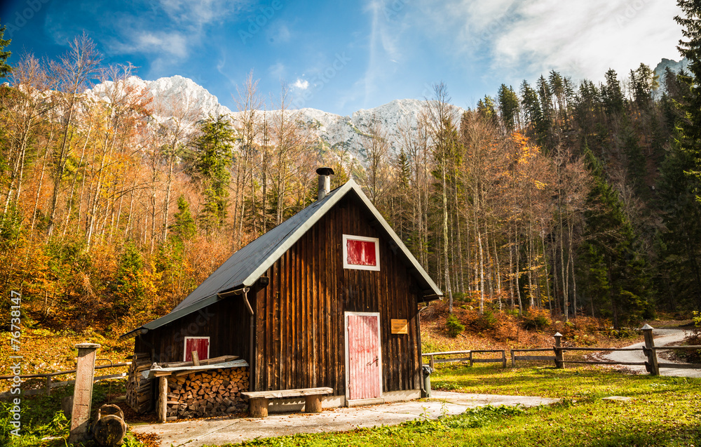 Fototapeta premium Alpine hut with a bench