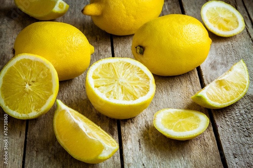 Fresh juicy lemons on a wooden background