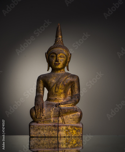 golden Buddha sculpture in meditation photo
