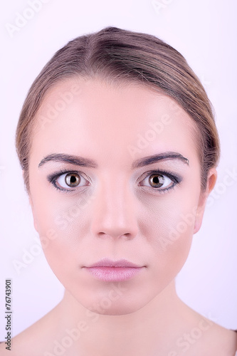 Applying makeup on female face, isolated on white background