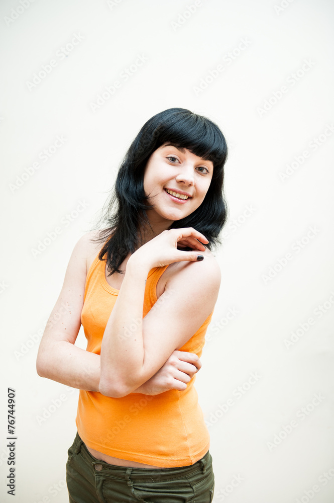 Girl smiling, orange t shrit, white background