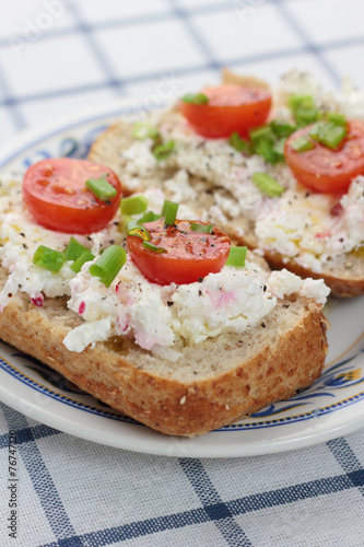 Cottage cheese with radish, chives and cherry tomatoes.