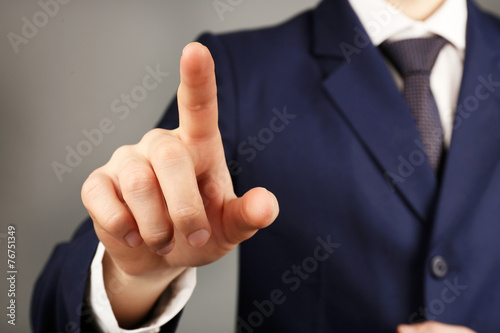 Businessman hand pushing screen, close-up