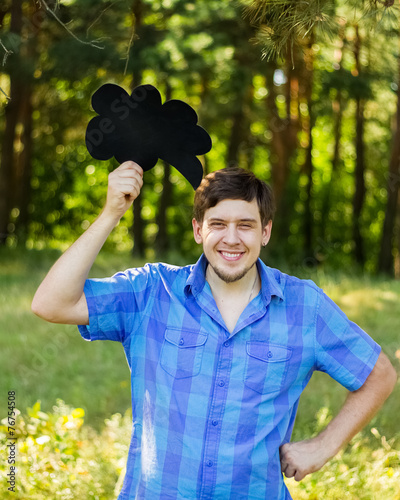 Happy beautiful manl holding a sign photo