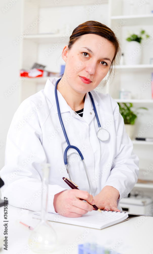 female doctor is writing prescription at the clinic female doctor is writing prescription at the clinic