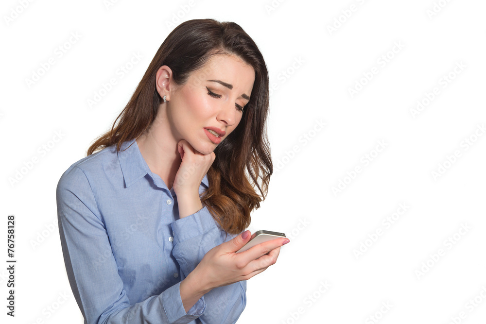 Troubled woman reading bad news on phone touching her head in mi Troubled woman reading bad news on phone touching her head in mi