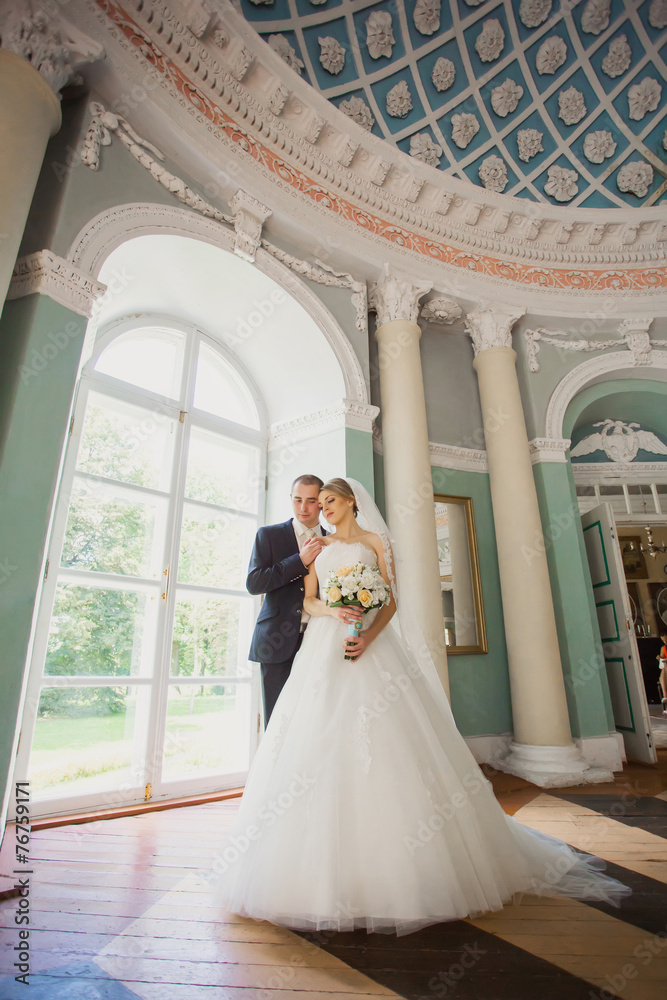 bride and groom embracing in the hall