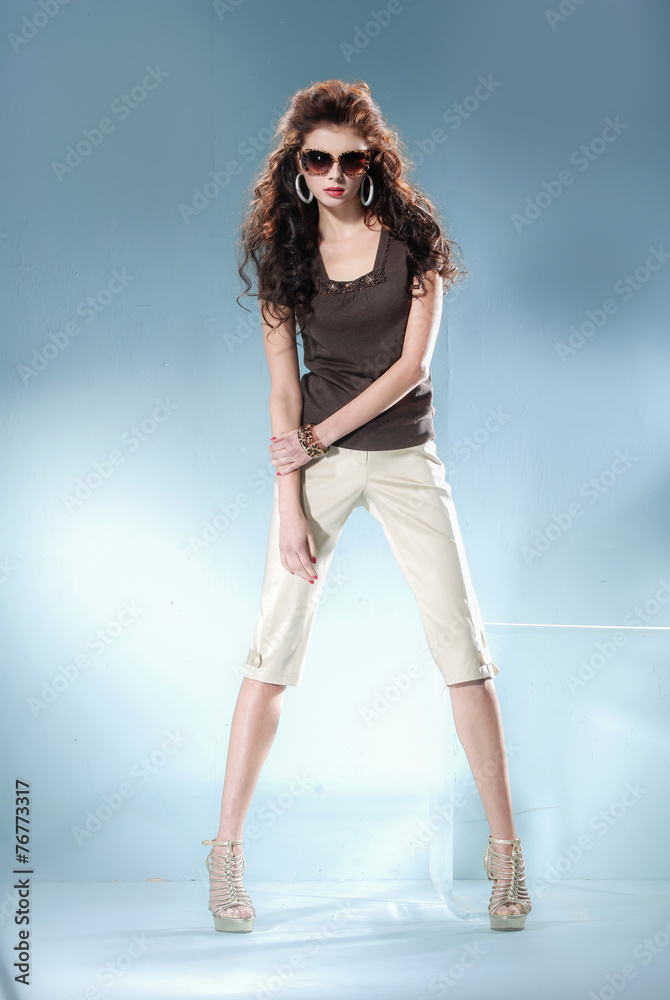 Full length fashion model wearing modern sunglasses posing Full length fashion model wearing modern sunglasses posing