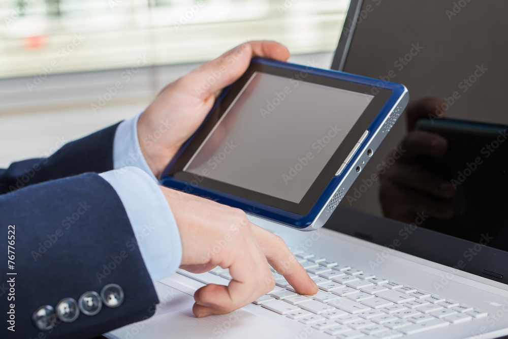 Businessman working on laptop and tablet Businessman working on laptop and tablet