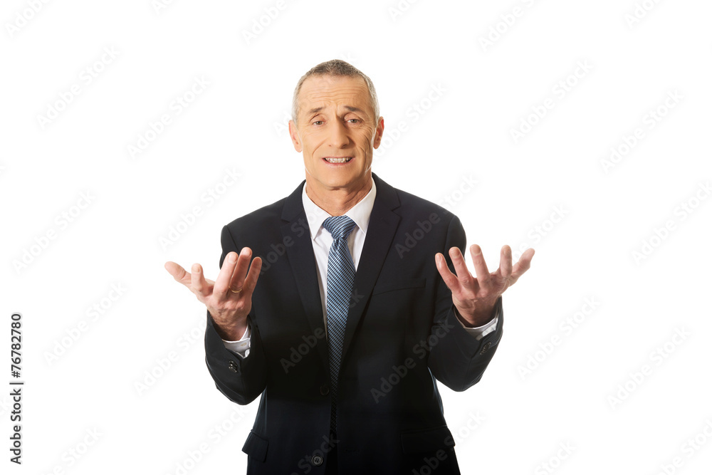 Businessman with open hands in undecided gesture Businessman with open hands in undecided gesture