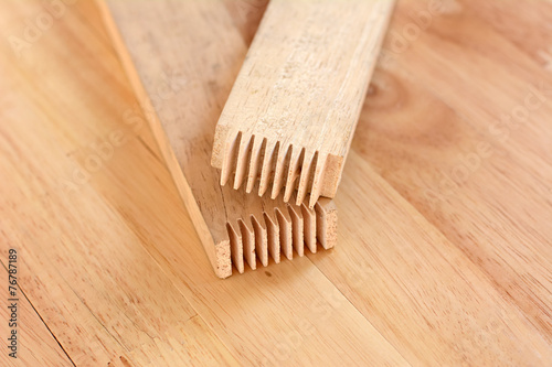 Finger joint at the end of wood sticks (or lumber) photo