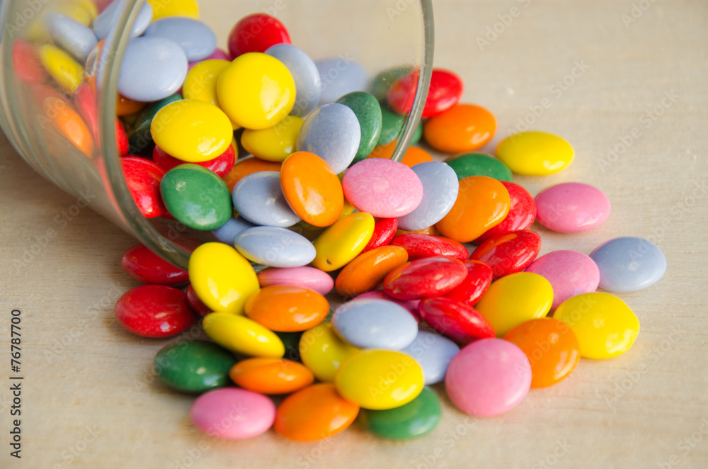 Colorful sugar-coated chocolate smarties in a glass Colorful sugar-coated chocolate smarties in a glass