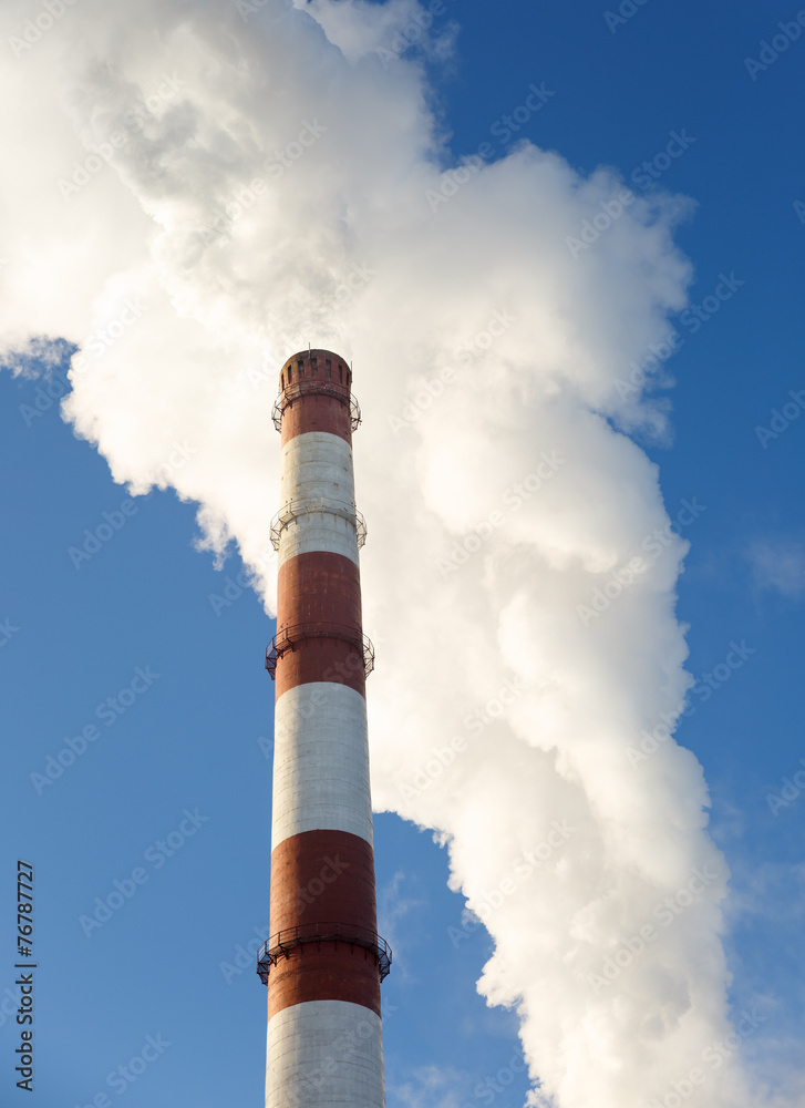 Day view of power plant, smoke from the chimney Day view of power plant, smoke from the chimney