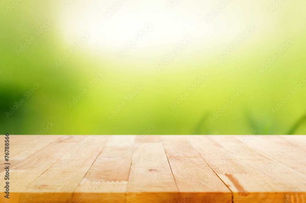 Wood table top on abstract nature green background