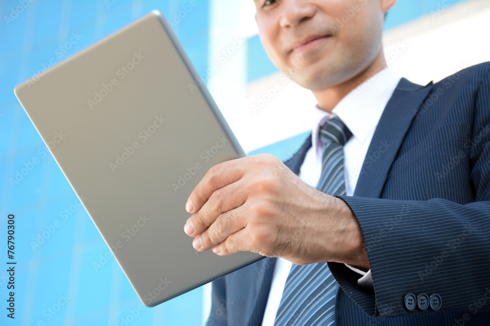 Businessman looking at tablet pc Businessman looking at tablet pc