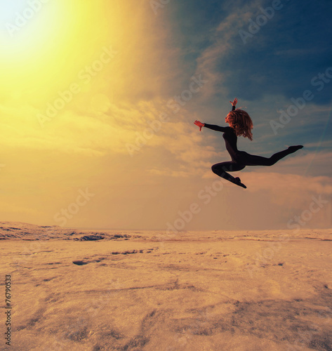 beautiful beautiful girl jumping in the snow