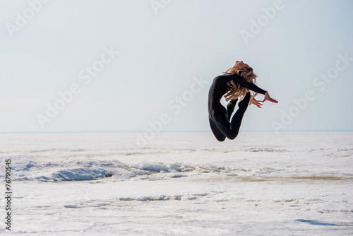 girl jumping and flexes back photo