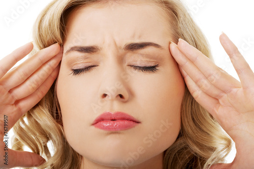 Portrait of young woman with huge headache