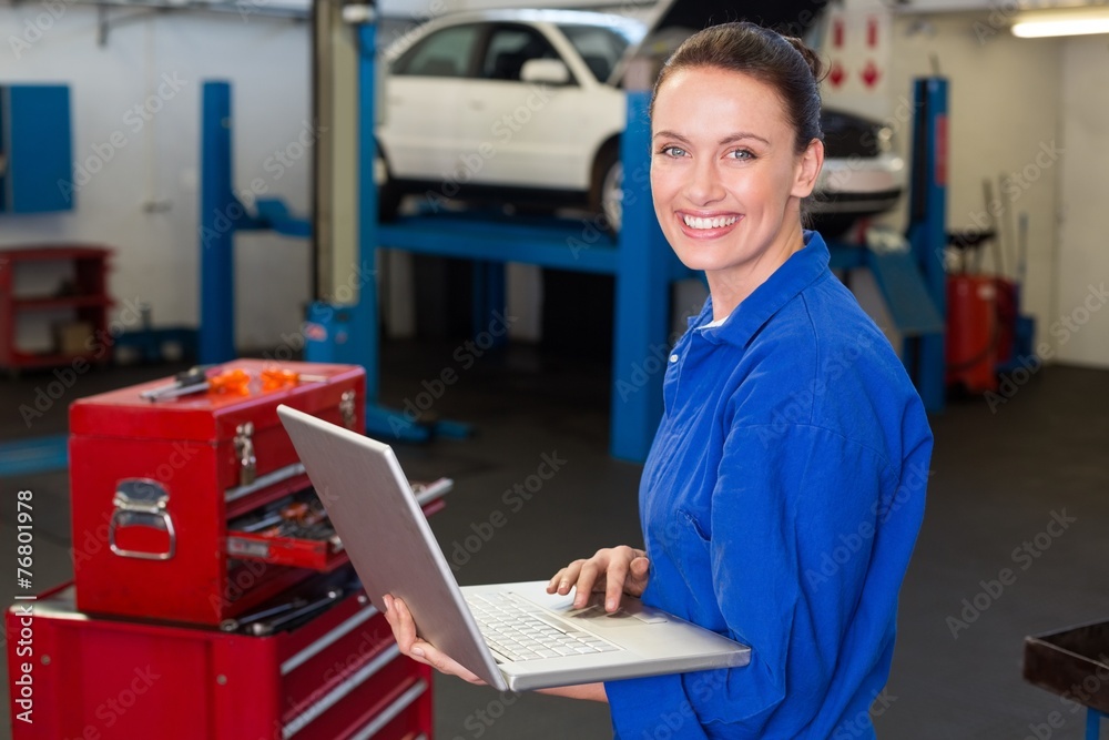 Mechanic typing on a laptop Mechanic typing on a laptop