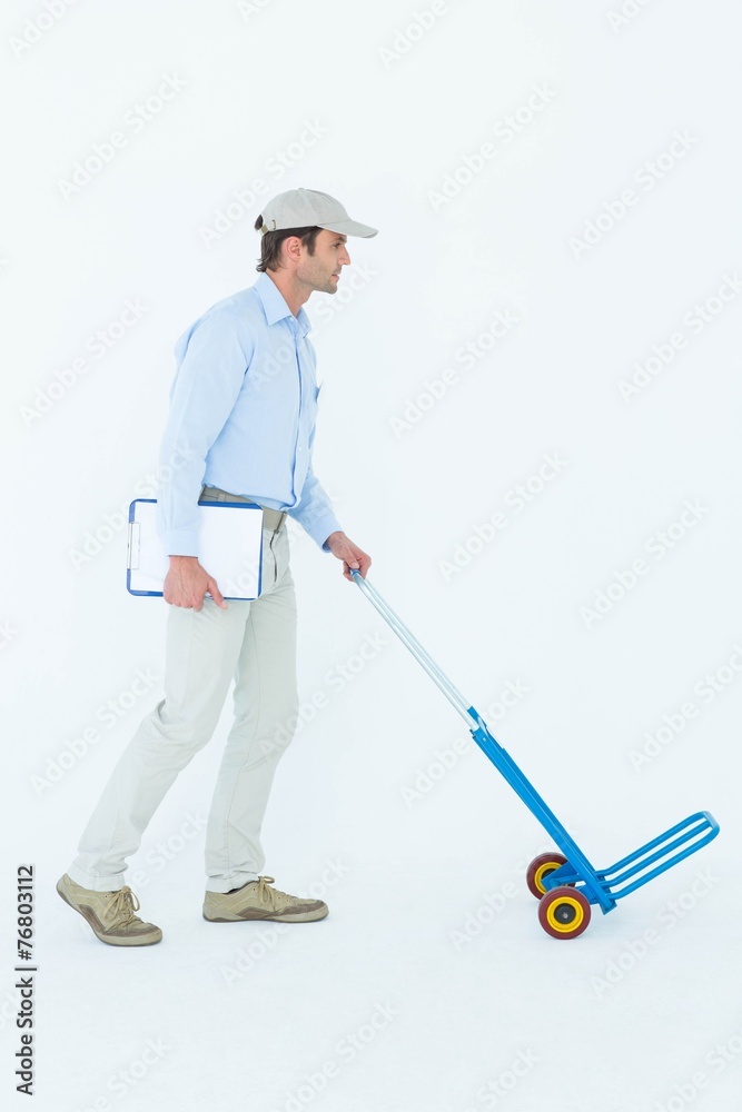 Delivery man pushing empty trolley