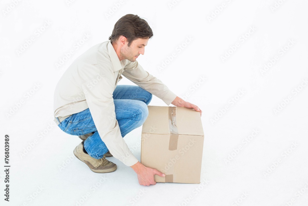 Delivery man picking cardboard box