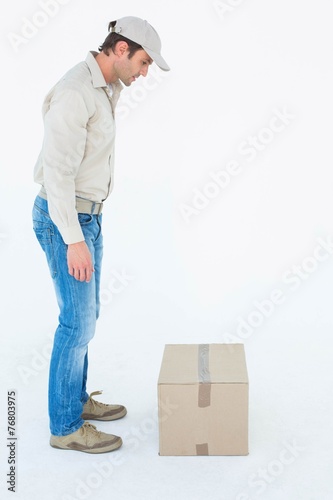 Delivery man looking at cardboard box