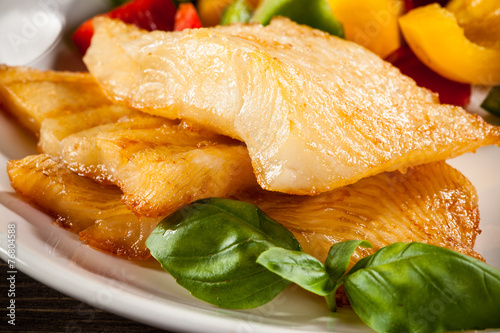 Slika na platnu Fish dish - fried halibut and vegetables