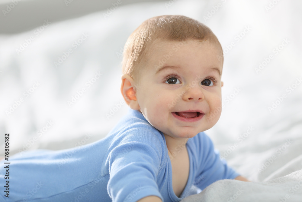 8-month-old baby boy laying on bed 8-month-old baby boy laying on bed