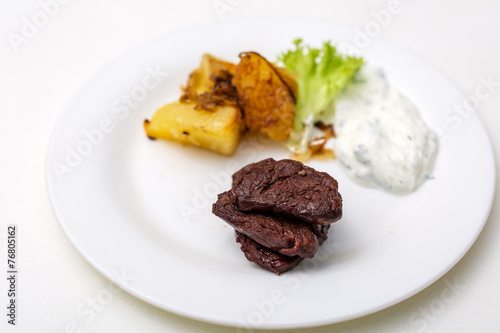 plate with beef and potatoes and gravy
