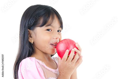 Little indian girl eating apple
