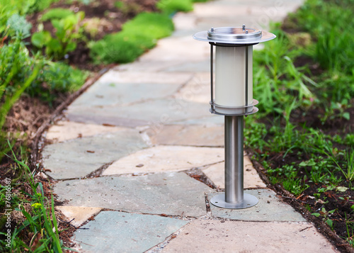 Solar-powered lamp on garden path.