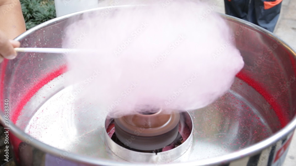 Machine making cotton candy at the festival. Machine making cotton candy at the festival.