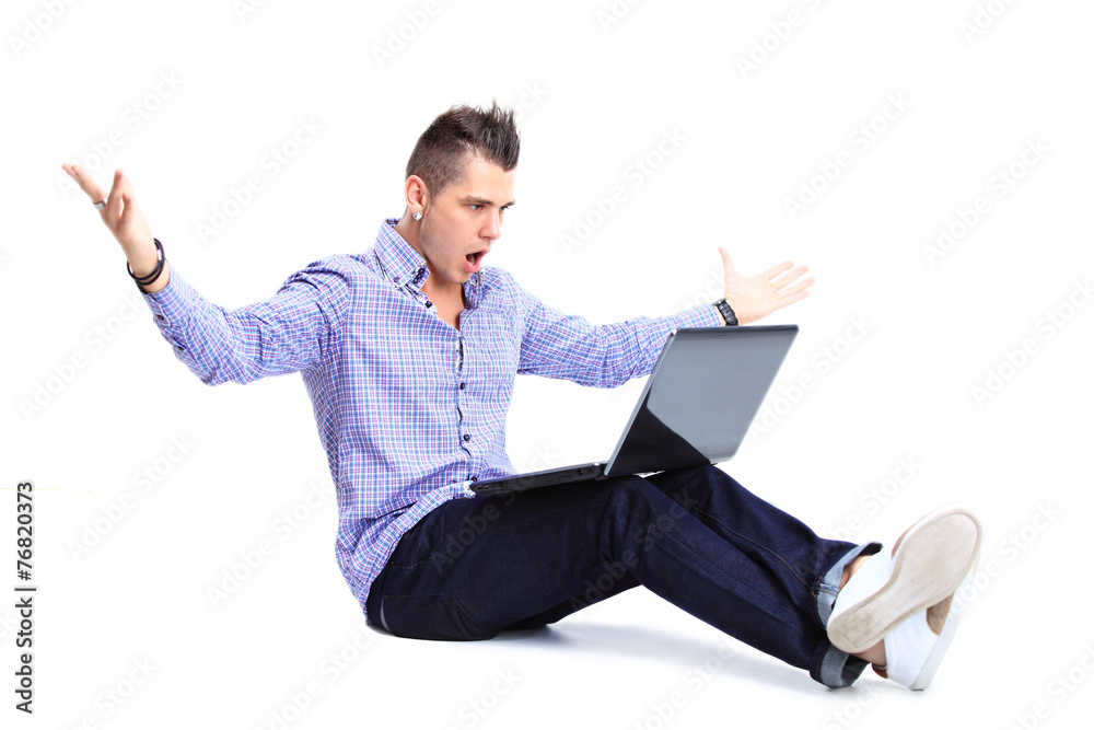 Portrait of happy man working on laptop in casuals Portrait of happy man working on laptop in casuals