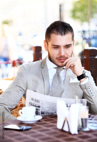 Handsome man reading a newspaper