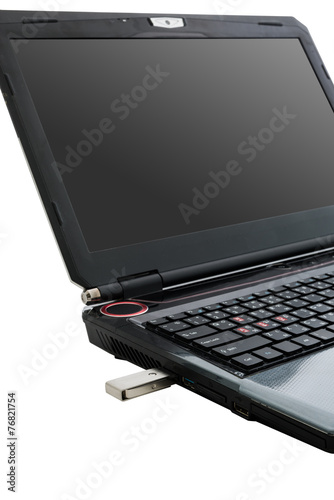 Flash memory drive plugged into a laptop port.