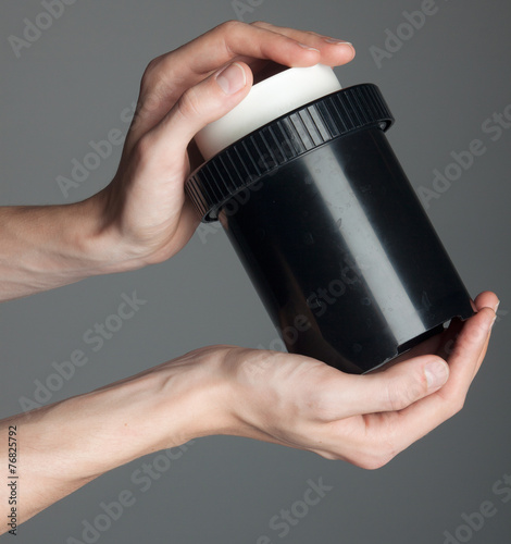 Fotografija film developing with tank, on grey background