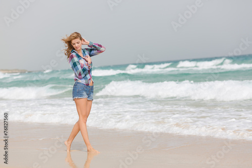 Junge Frau geht am Strand spazieren