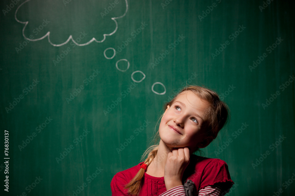 Little girl standing in front of chalkboard with cloud Little girl standing in front of chalkboard with cloud
