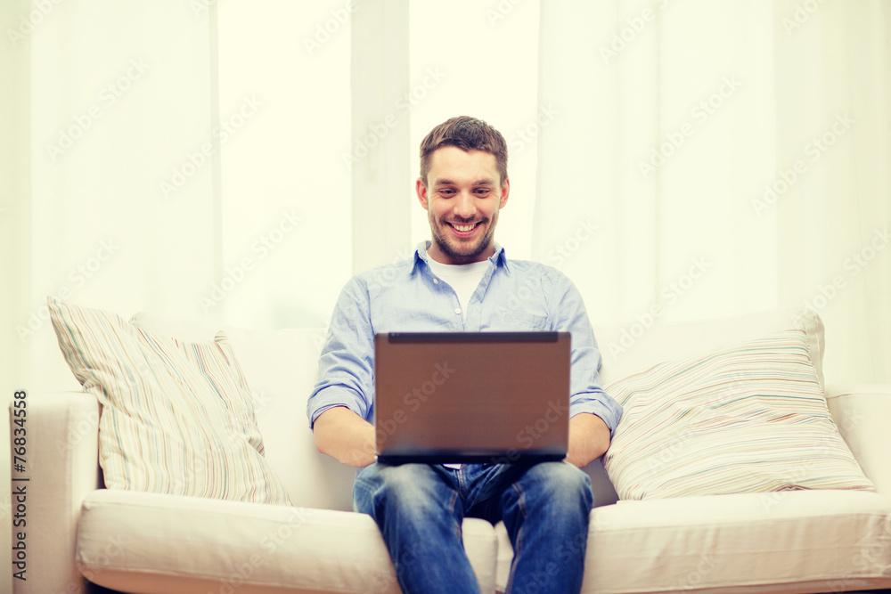 smiling man working with laptop at home smiling man working with laptop at home