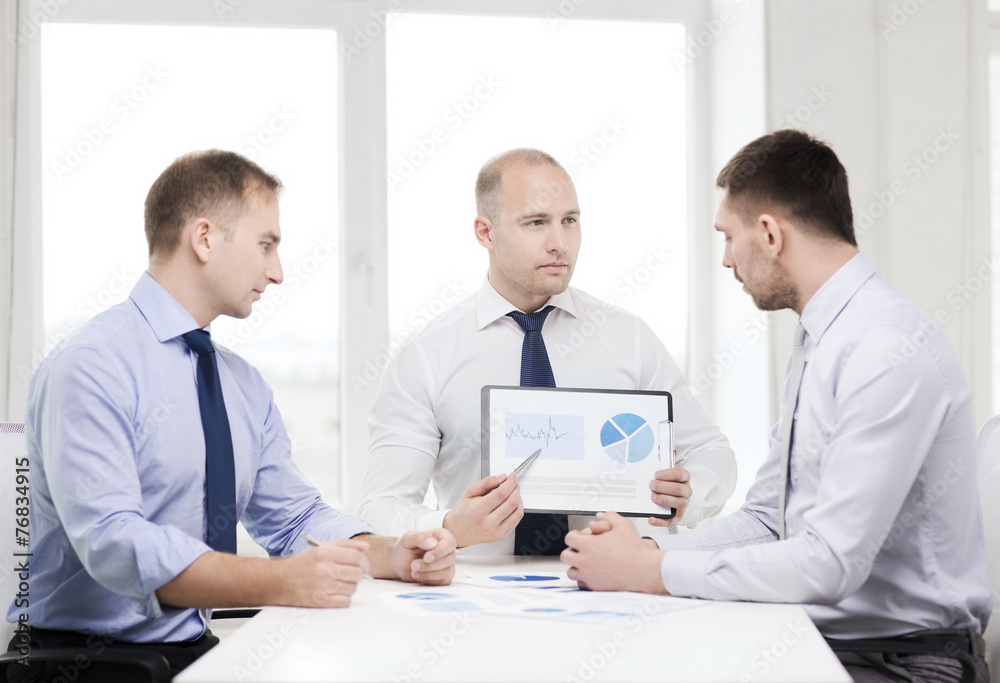 serious businessmen with papers in office serious businessmen with papers in office