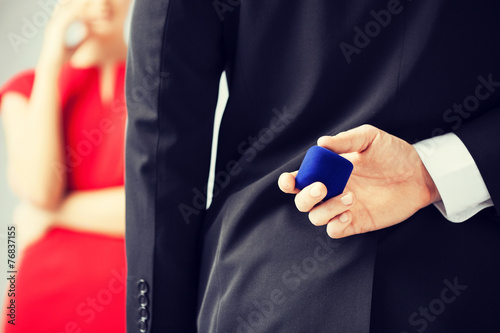 man with wedding ring and gift box